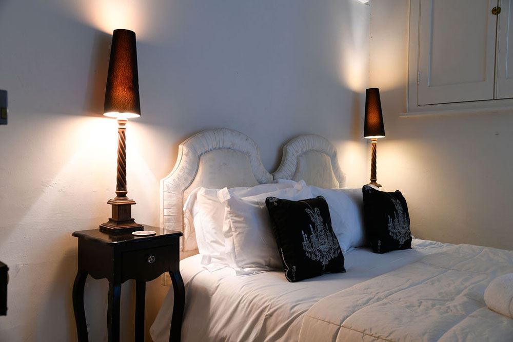 Interior shot of the ground floor double bedroom at Lorton House with feature lamps and bedside tables eitherside of a double bed.