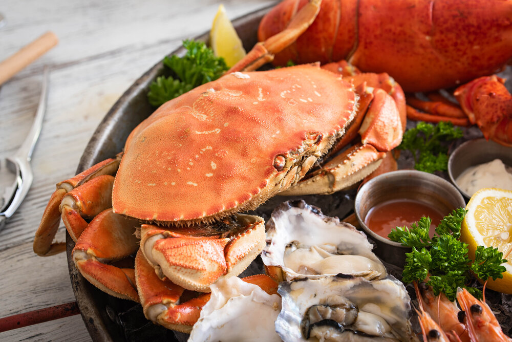 Boiled Dungeness crab on a plate of seafood.