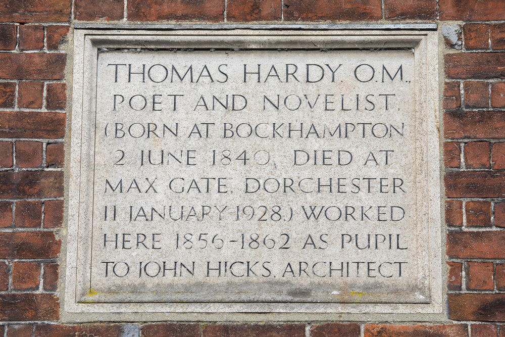 A plaque marking the location where Poet and Novelist Thomas Hardy once worked, on South Street in Dorchester, Dorset,