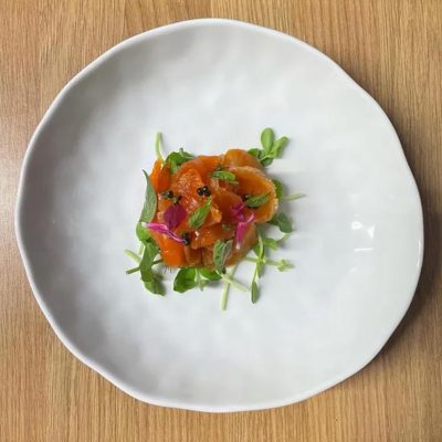Fine dining food arrange in the middle of a white plate